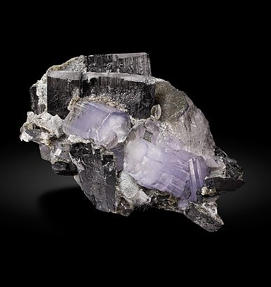 Fluorapatite with Ferberite, Quartz and Muscovite.