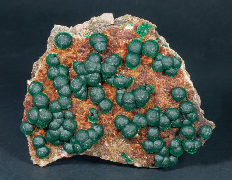 Malachite on Quartz with Goethite inclusions.