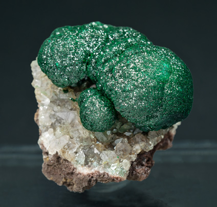 Malachite on Quartz with Goethite inclusions.