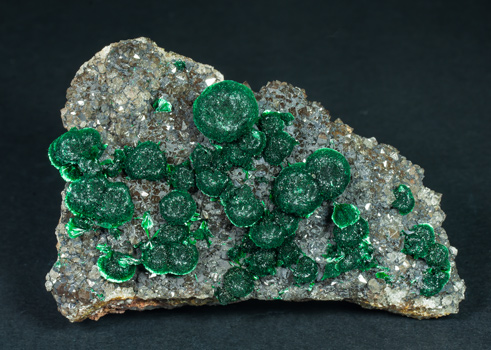 Malachite on Quartz with Goethite inclusions. 