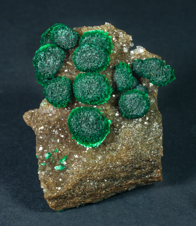 Malachite on Quartz with Goethite inclusions.