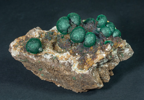 Malachite on Quartz with Goethite inclusions. 