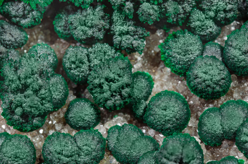 Malachite on Quartz with Goethite inclusions. 