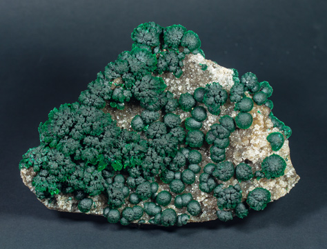 Malachite on Quartz with Goethite inclusions.