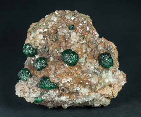 Malachite on Quartz with Goethite inclusions.