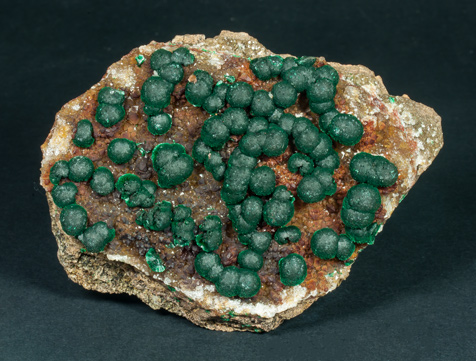 Malachite on Quartz with Goethite inclusions.