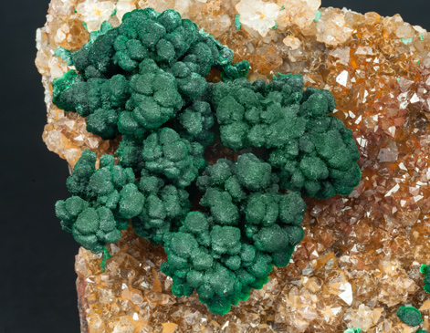 Malachite on Quartz with Goethite inclusions. 