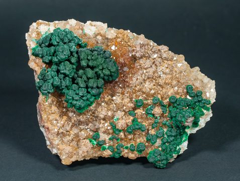 Malachite on Quartz with Goethite inclusions.